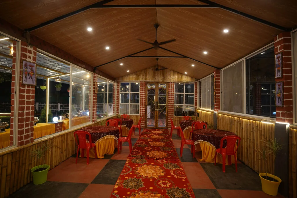Banquet hall with tables and chairs at Kunj Resort